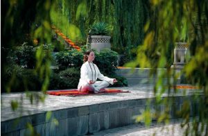 Woman Meditating in a yoga pose - Rishikesh Spa