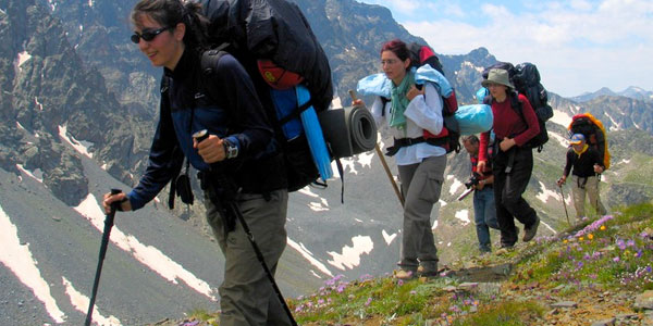 Group of Hikers Walking In Mountain