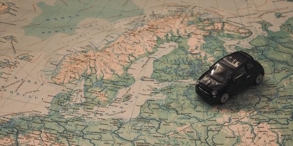 Image Represents Travel Concept - Car Kit placed on the Antique Map.